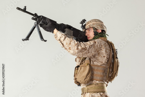 Soldier in camouflage holding rifle