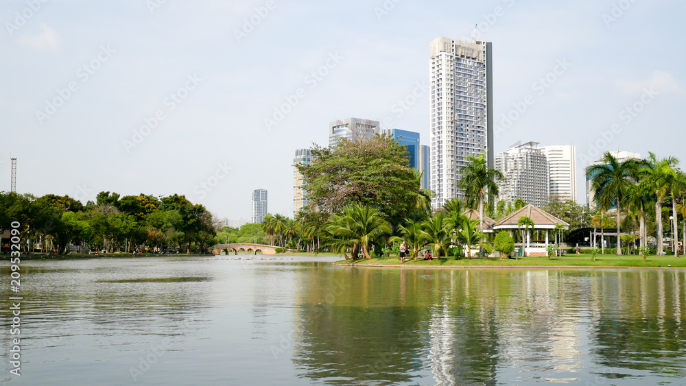 BANGKOK, THAILAND - MARCH 8, 2017: A large pool with beautiful sky in the Jatujak park that is the place for people to relax in Bangkok in the afternoon