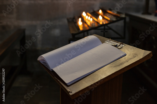 votive altar in church with emtpy guestbook photo