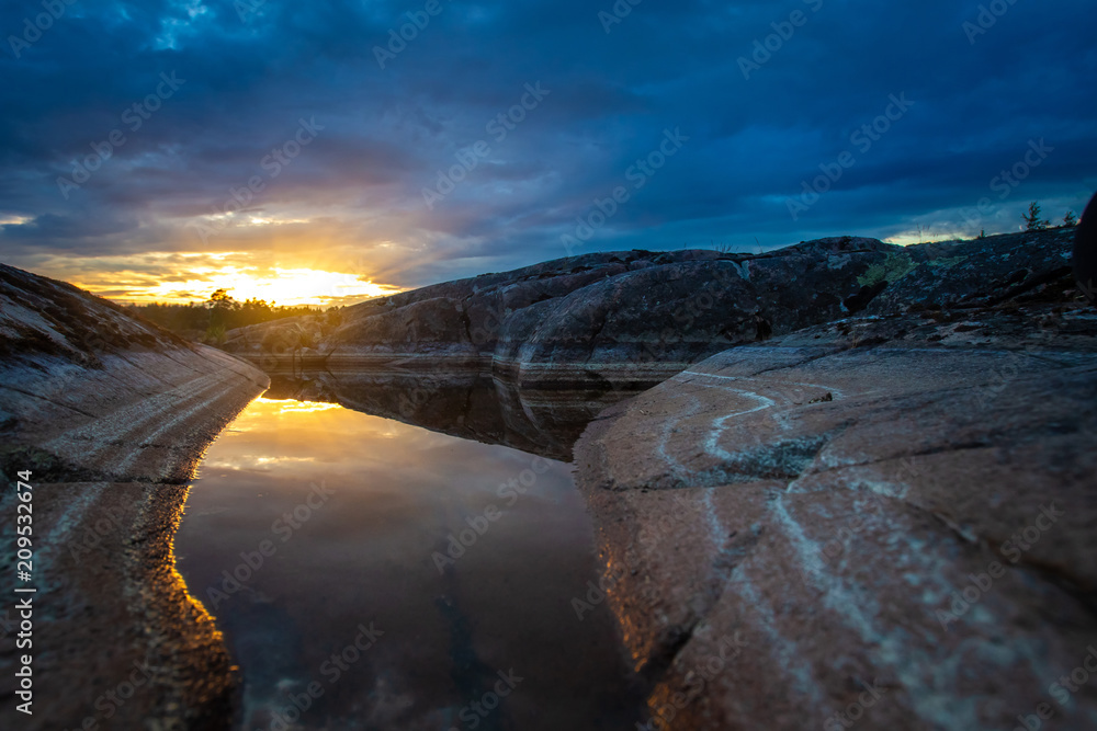 The sunset reflects on the stone. Stones with divorces. Natural stone. Rocks on the shore. Wild places. The sunset reflects on the stone. Stones with divorces. Natural stone. Rocks on the shore. Wild places.