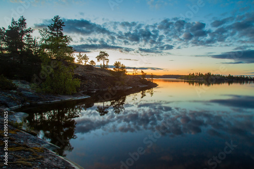 Dawn on the lake. The clouds are reflected in the water. Karelia. Ladoga lake. Nature of Russia. The Republic of Karelia.