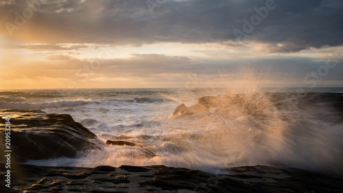 Splashing Waves in Muriwai Beach, West Auckland, New Zealand photo