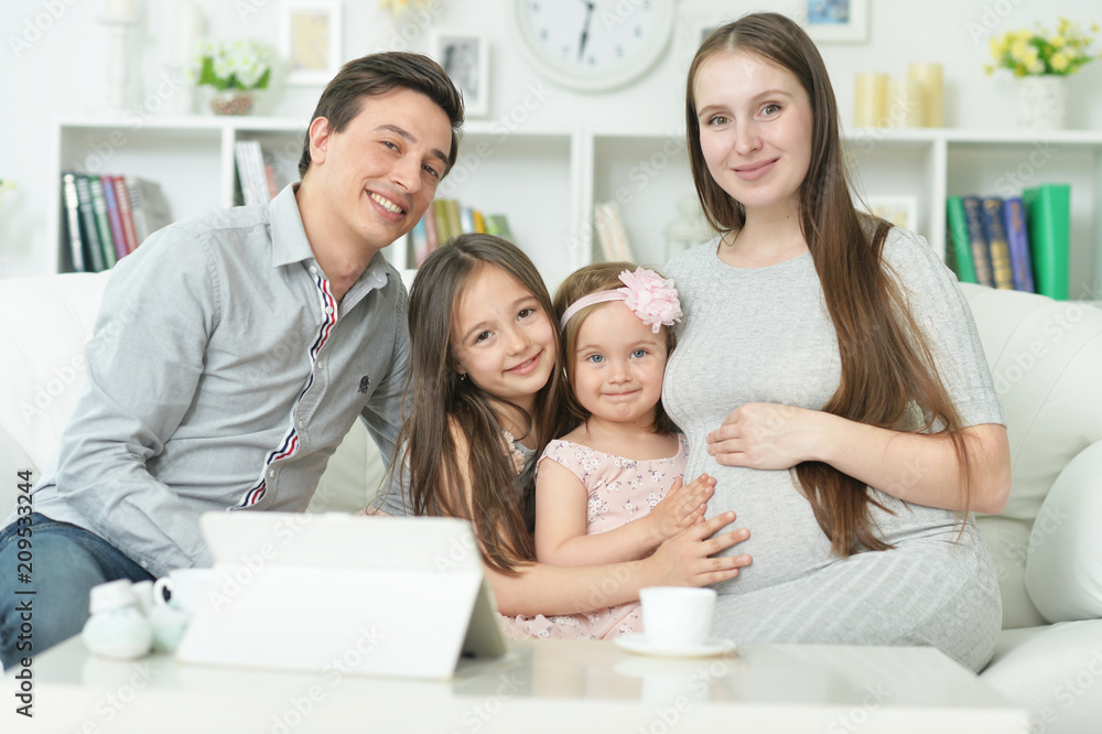 happy pregnant woman with husband and daughters happy pregnant woman with husband and daughters