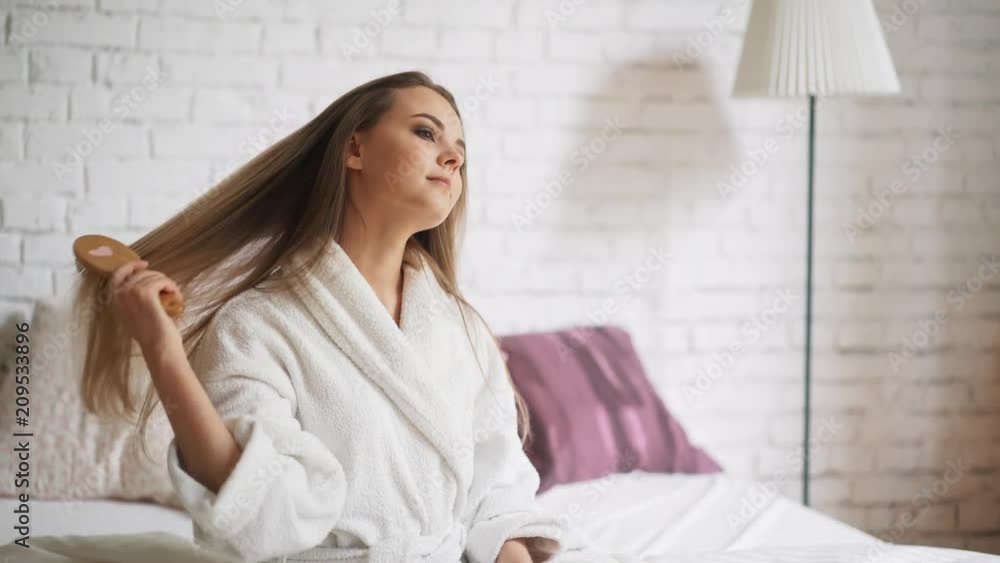 Beautiful woman with long hair angry about loosing it after brushing Beautiful woman with long hair angry about loosing it after brushing