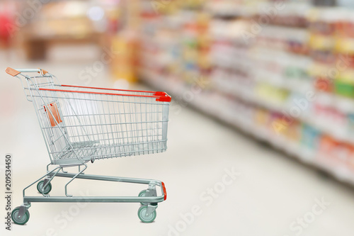 Wallpaper Mural Supermarket aisle with empty shopping cart at grocery store retail business concept Torontodigital.ca