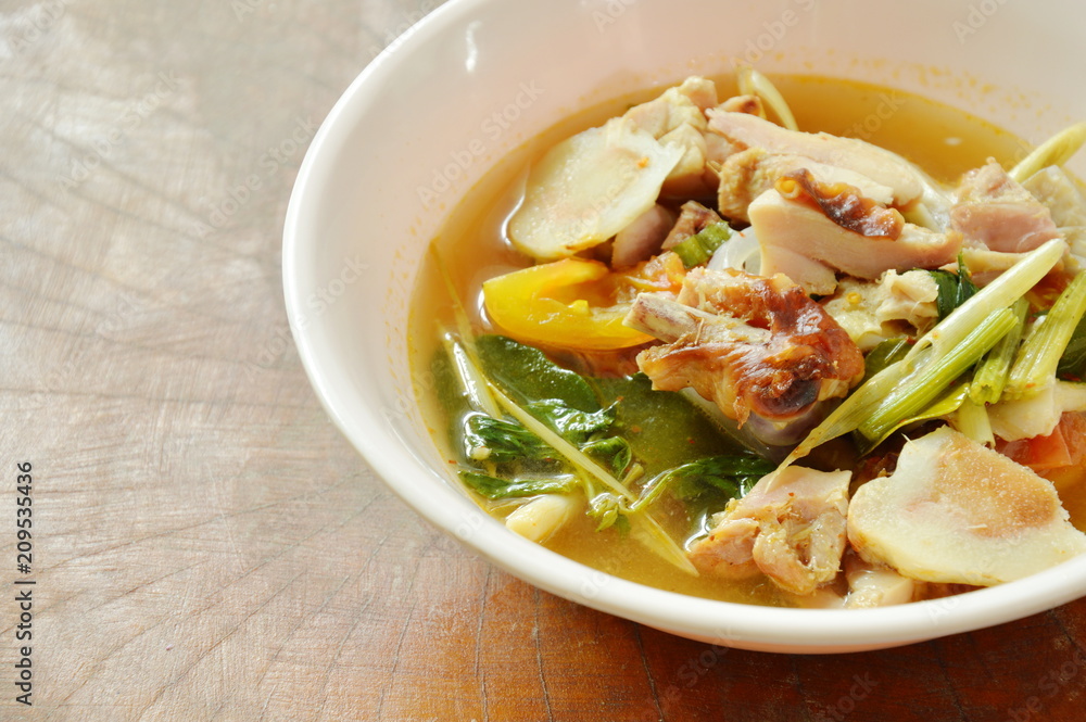 boiled grilled chicken with mushroom and tomato in tom yum spicy soup on bowl boiled grilled chicken with mushroom and tomato in tom yum spicy soup on bowl