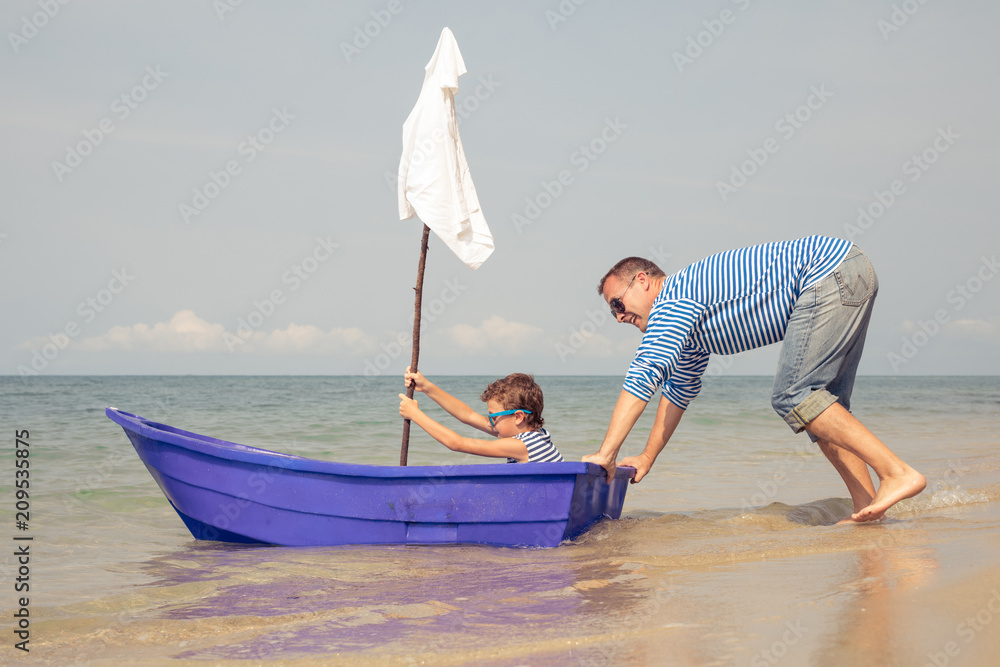 Naklejka premium Father and son playing on the beach at the day time.