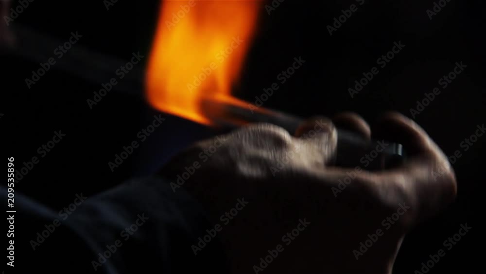 Detail of a Neon Sign Being Manufactured in a Neon Sign Shop, Worker Bending the Glass using a Gas-burner, Production of Neon Tubes. Close Up. Detail of a Neon Sign Being Manufactured in a Neon Sign Shop, Worker Bending the Glass using a Gas-burner, Production of Neon Tubes. Close Up.