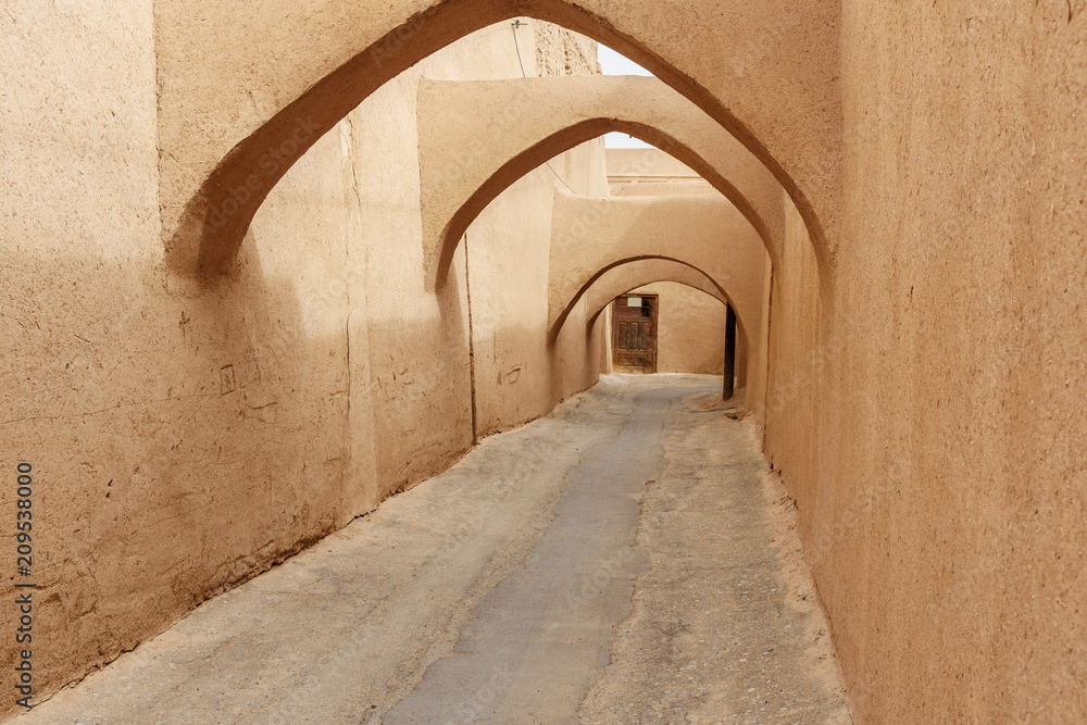 Narrow street with arches of old town in Yazd. Iran