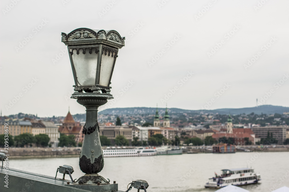 bridge and lantern concept in gray rainy day in old urban city district in Budapest 