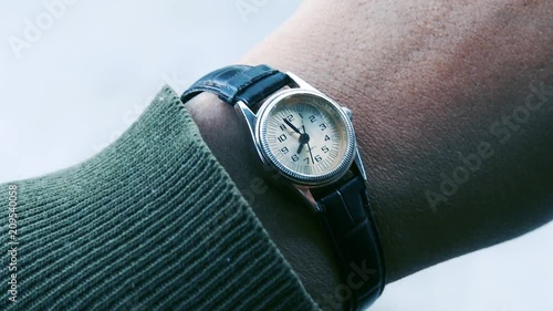 Close-Up Of Male Hand Checking Time On Wristwatch. Zoom In.  photo