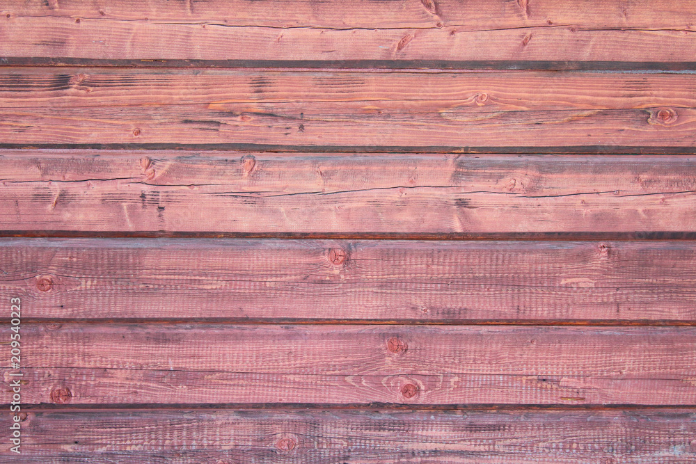 The wall of the house is made of a square beam and a tow. Close-up. Background. Texture. The wall of the house is made of a square beam and a tow. Close-up. Background. Texture.