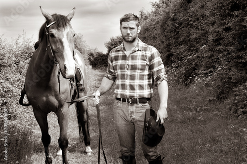 Handsome cowboy, horse rider on saddle, horseback adn boots © Tony Marturano