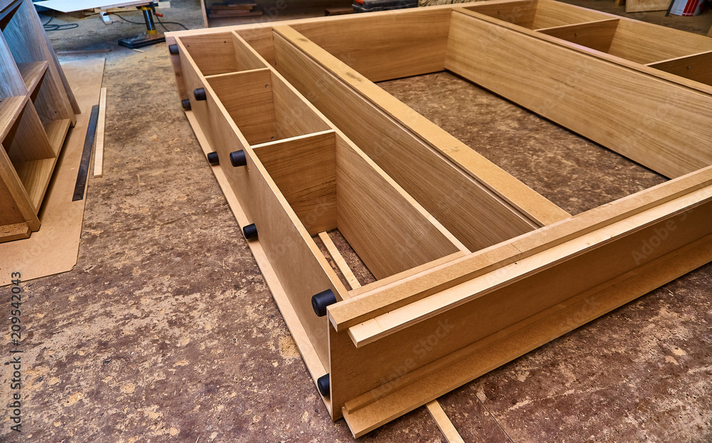 Joinery. Oak veneered mdf wardrobe in workshop. Wooden furniture. Details wood production Joinery. Oak veneered mdf wardrobe in workshop. Wooden furniture. Details wood production