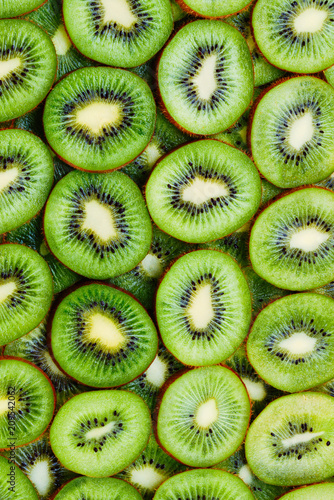 top view of heap of sliced kiwi as textured background