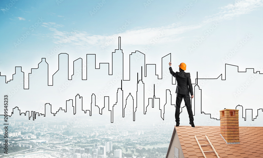 Man architect draw silhouette of modern city on blue sky. Mixed media Man architect draw silhouette of modern city on blue sky. Mixed media