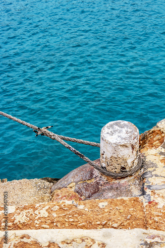 Mooring bollard with a rope, Blue Lagoon, Comino Island harbor, Malta