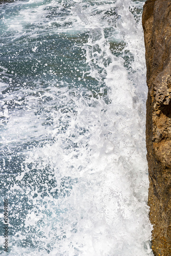 Wave crashes against limestone rocks at Dwejra Bay, Gozo, Malta