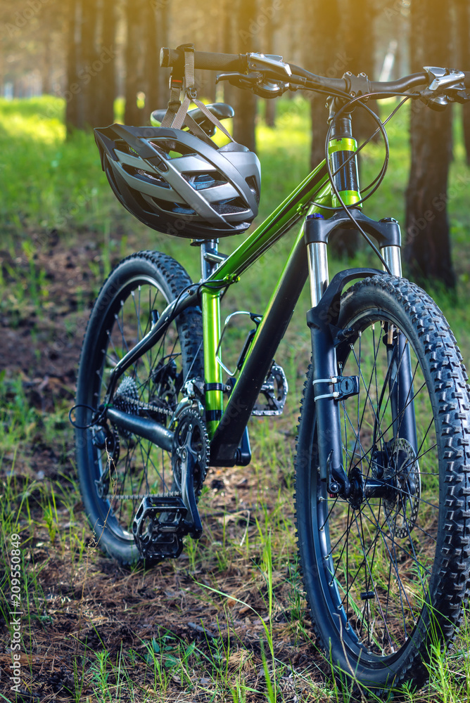 Fototapeta premium Sports helmet on a mountain bike in the Park. Concept protection during active and healthy lifestyle