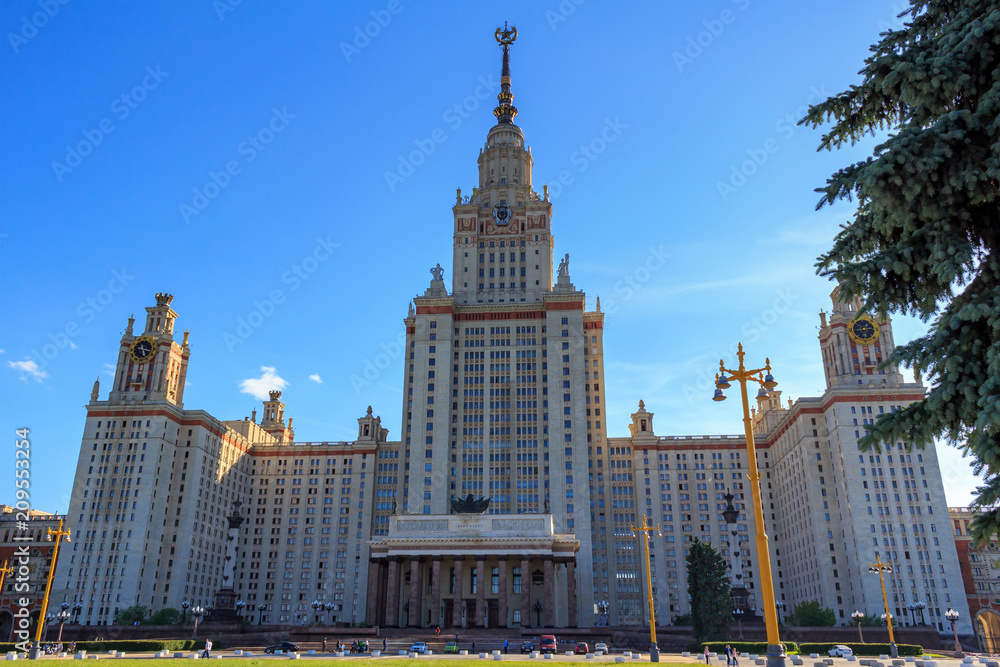Main building of Lomonosov Moscow State University (MSU) against blue sky in sunny summer evening