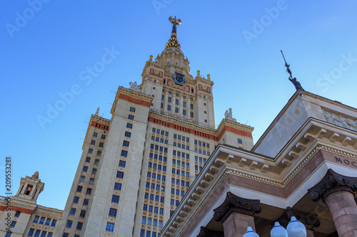 Tower of main building of Lomonosov Moscow State University (MSU) against blue sky in sunny summer evening