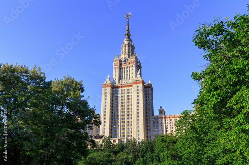 Lomonosov Moscow State University (MSU) in sunny summer evening against green trees