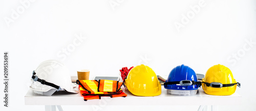 Safety helmet and equipment work of the engineers, construction on the white table.