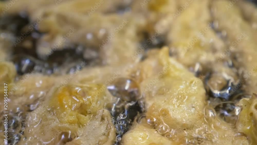 Typical Italian specialty - frying tasty artichokes in olive oil Typical Italian specialty - frying tasty artichokes in olive oil