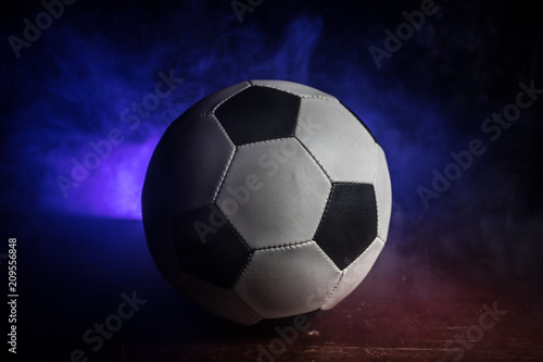 Close up view of soccer ball on dark background. FootSelective focus