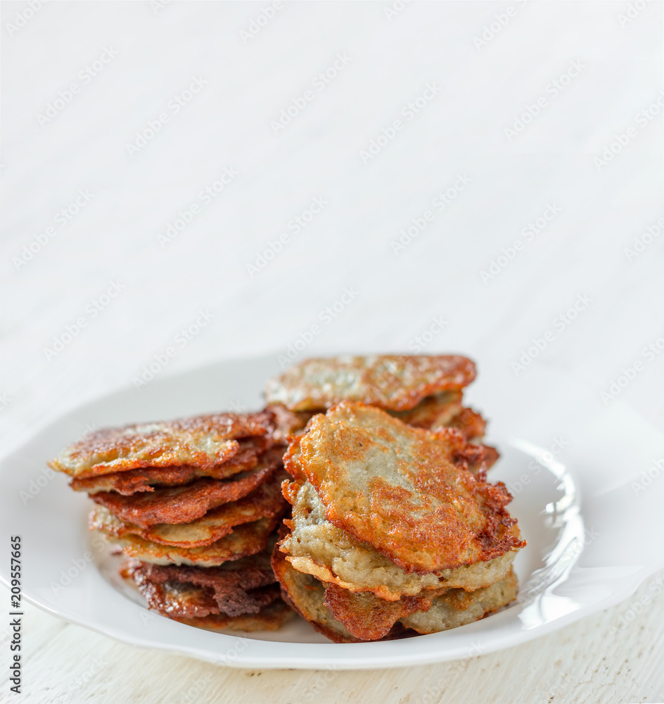fresh homemade potato pancakes on a plate close-up with copy space fresh homemade potato pancakes on a plate close-up with copy space