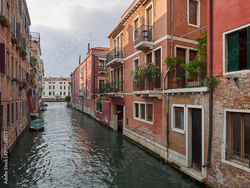 Tranquil back canal with colorful historic houses with balconies and greenery, Venice, Veneto, Italy , a popular tourist destination