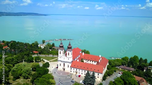 Tihany, Hungary - 4K flying around full circle of Benedictine Monastery of Tihany with beautiful colourful Lake Balaton