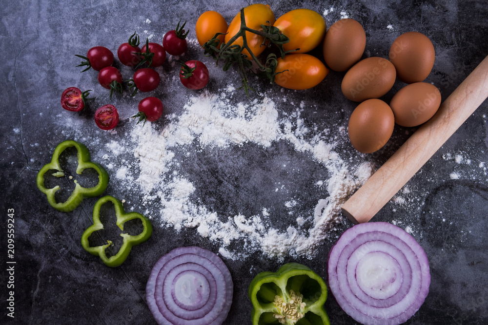Wheat flour and fresh vegetables on table. Homemade pastry for bread, pizza or pie. Bakery background