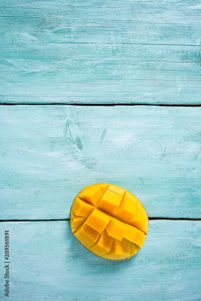 mango fruit on turquoise wooden surface