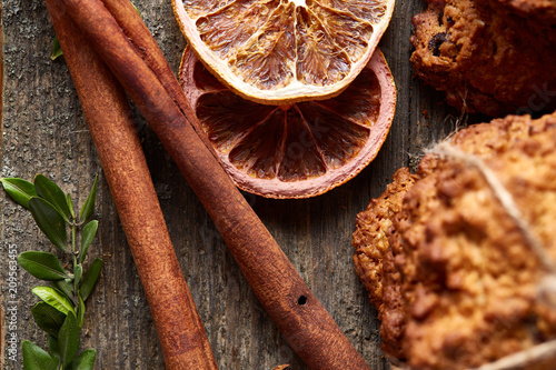 Christmas composition with oatmeal, chocolate biscuits, and spices, on wooden background, close-up, selective focus.