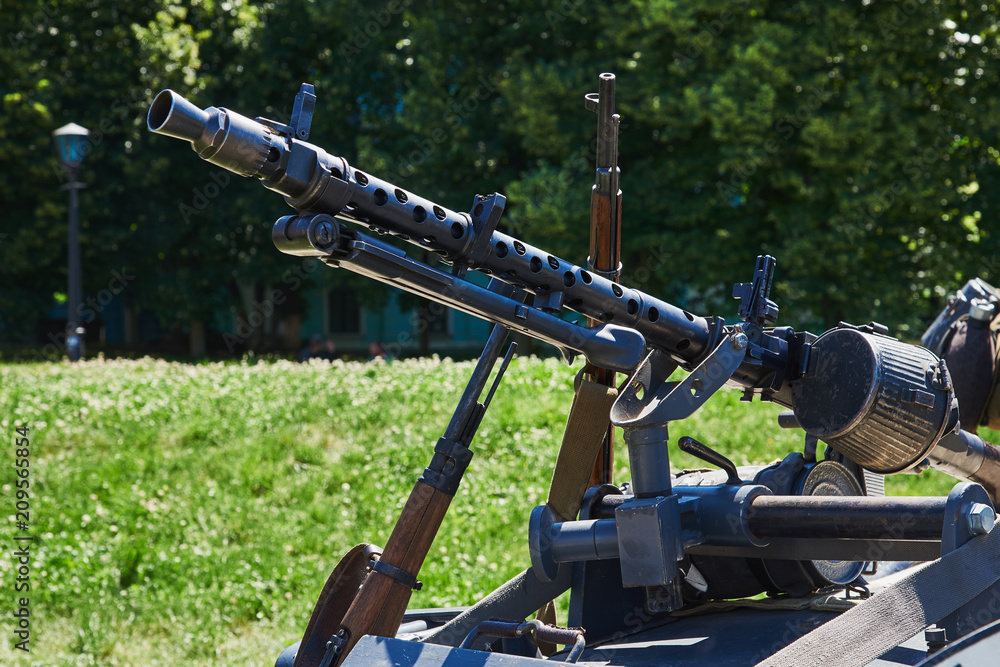 The machine gun is fixed on the buggy of the motorcycle. Rifles are leaning against the buggy of a motorcycle. German weapons of the Second World War The machine gun is fixed on the buggy of the motorcycle. Rifles are leaning against the buggy of a motorcycle. German weapons of the Second World War