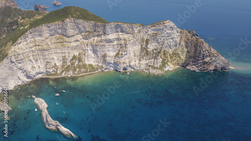 Aerial view of the island of Palmarola, in the archipelago of the Ponziane Islands west of Ponza, in the Tyrrhenian Sea, in Italy. The island has a sea and beautiful coast where boats dock.