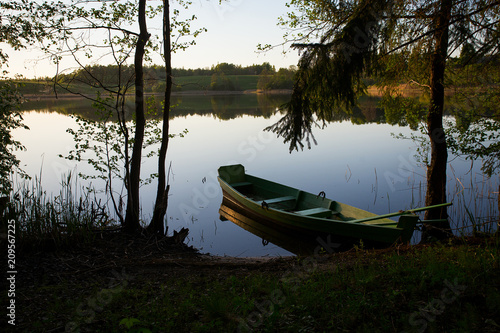 fishing boat in a calm lake water