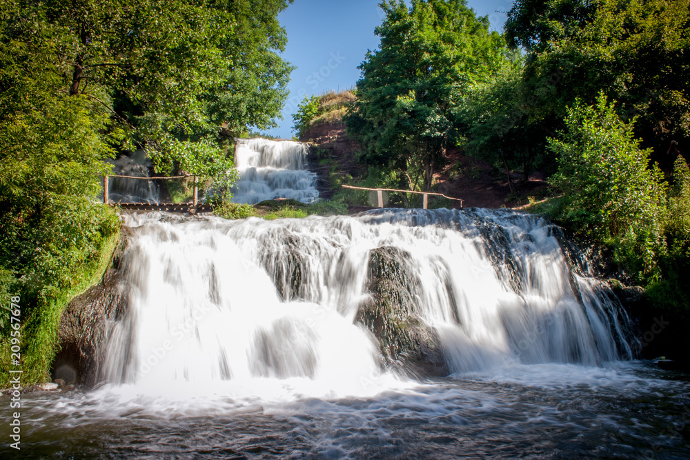 Fototapeta premium Dzhurinsky waterfall - a waterfall on the river Dzhurin in Zaleschitsky district of Ternopil region of Ukraine. The height of the waterfall is 16 meters.