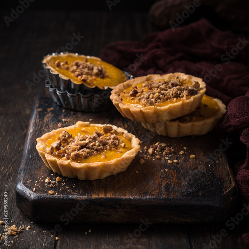 Obraz na plátne Pumpkin mini pie, tartlet made for Thanksgiving day on old wooden background
