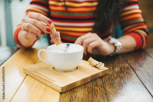 woman hands hold bowl with cream soup in cafe