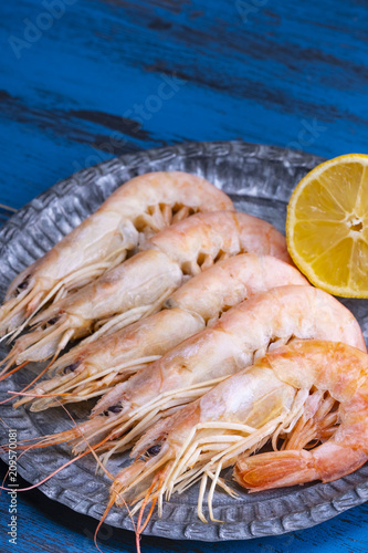 Cooked prawns on blue plate