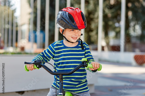 Kid with bike and helmet smiles