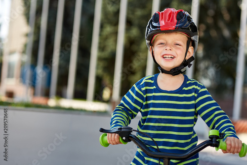 Kid with bike and helmet smiles