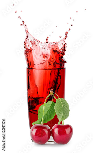 Splash in glass of cherry juice with berries of cherry