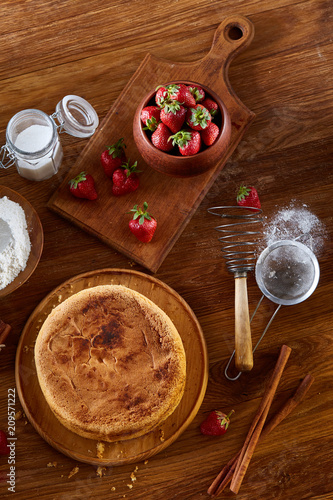 Top view raw ingredients for cooking strawberry pie or cake on wooden table, flat lay. Bakery background.