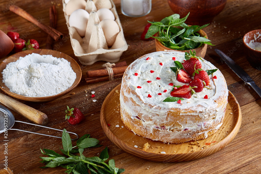 Strawberry tart covered with whipped sour cream on a wooden tray over rustic background, selective focus Strawberry tart covered with whipped sour cream on a wooden tray over rustic background, selective focus