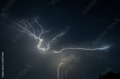 thunderstorm and lightning on a summer night over a sleeping city