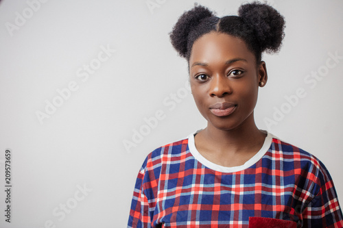 close-up portrait of black awesome hipster girl in funny T-shirt with two hair buns. copyspace photo