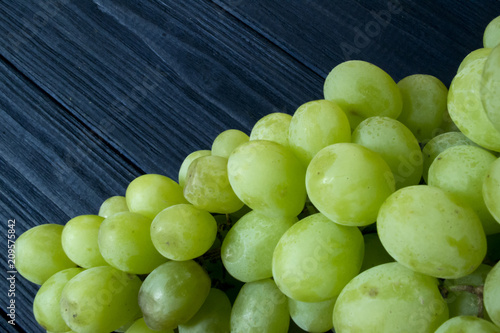 Ripe grapes on a dark blue wooden background.